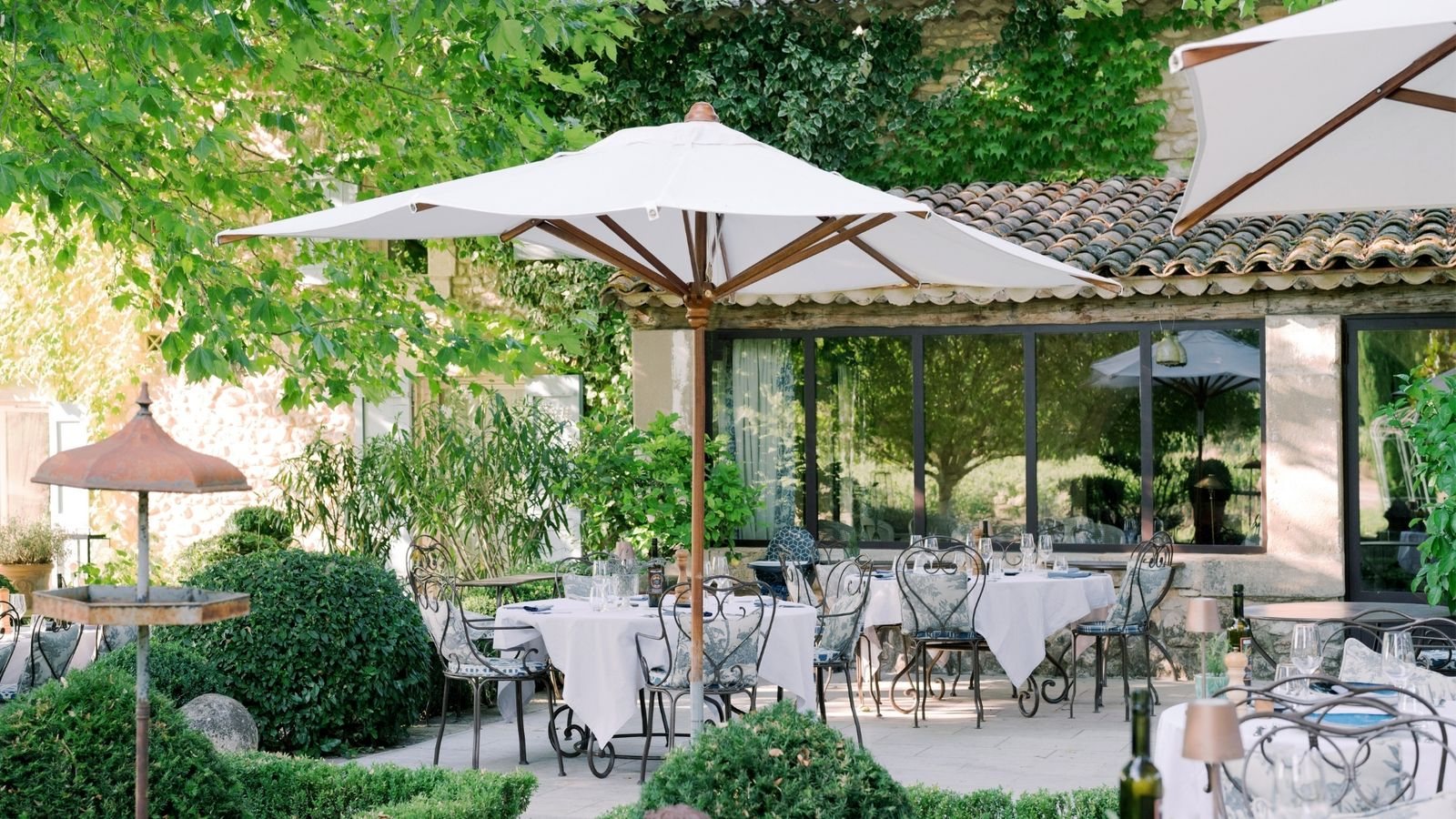 La Bastide de Marie’s shaded lunch terrace among the greenery.