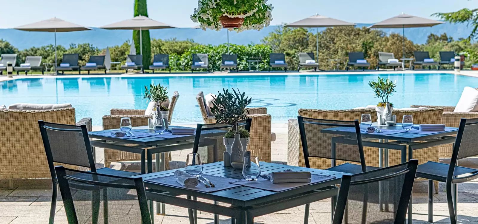 Lunch tables beside the swimming pool at Les Bories.